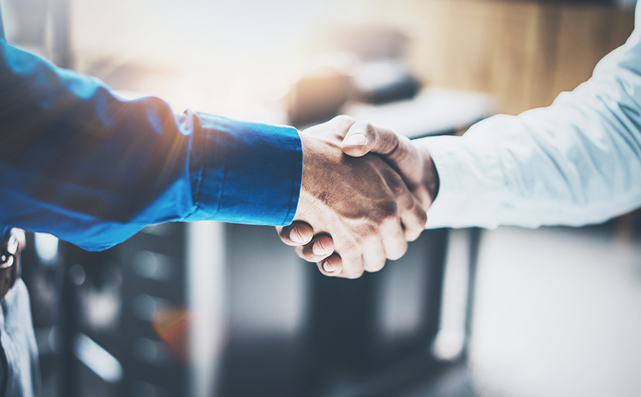 Close up view of business partnership handshake concept.Photo of two businessman handshaking process.Successful deal after great meeting.Horizontal, blurred background